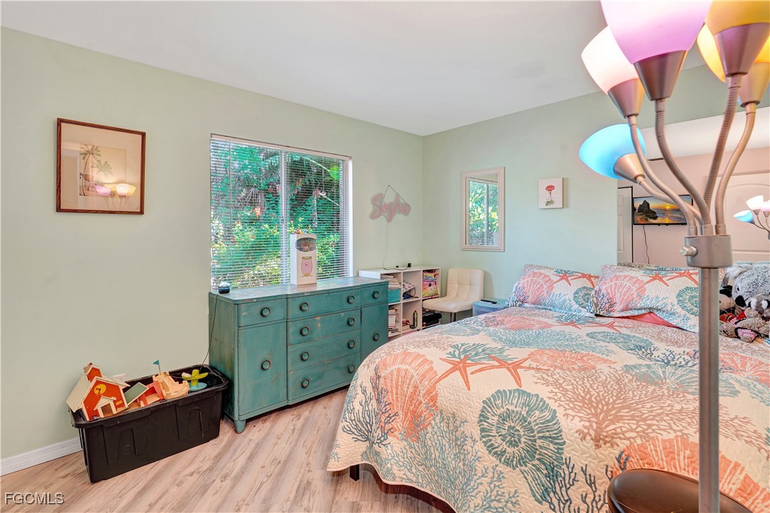 5887 Kingfish Road Bokeelia, FL 33922 - Photo 11 of 34 a bedroom with a bed and a window