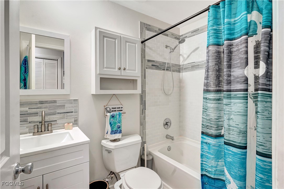 5887 Kingfish Road Bokeelia, FL 33922 - Photo 15 of 34 a bathroom with a sink toilet and shower