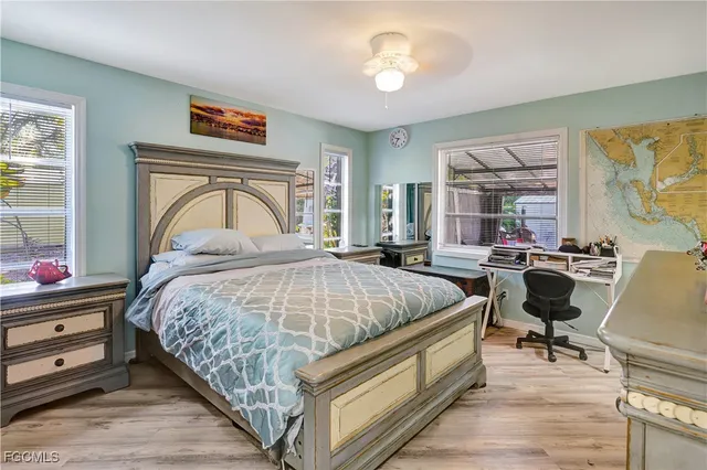 a bedroom with bed and wooden floor