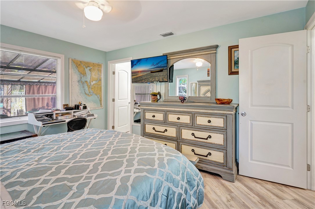5887 Kingfish Road Bokeelia, FL 33922 - Photo 17 of 34 a large bedroom with a bed and a dresser