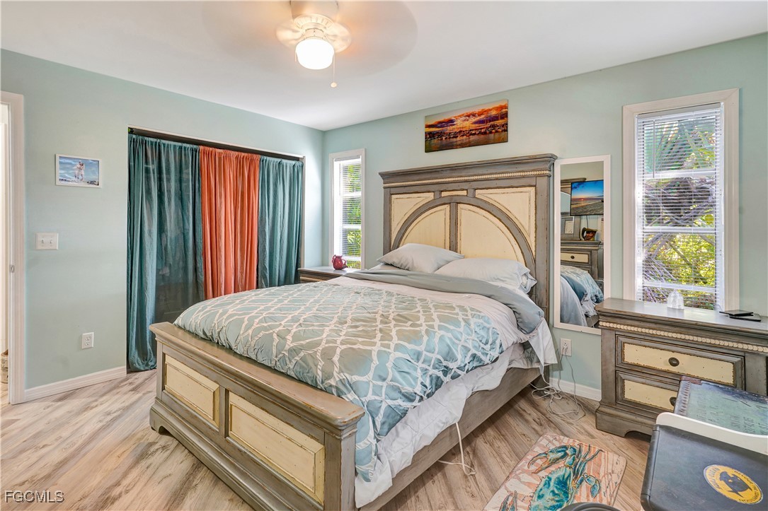 5887 Kingfish Road Bokeelia, FL 33922 - Photo 18 of 34 a spacious bedroom with a bed and a window