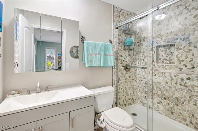 a bathroom with a sink a toilet and shower curtain