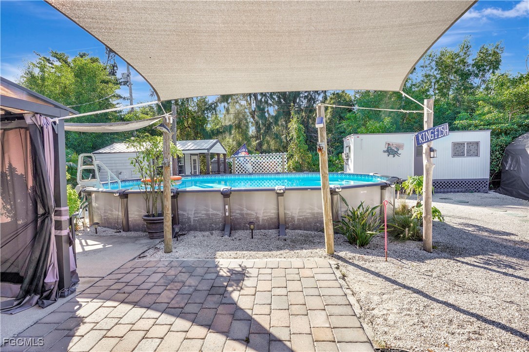 5887 Kingfish Road Bokeelia, FL 33922 - Photo 20 of 34 a view of a patio with a table and chairs