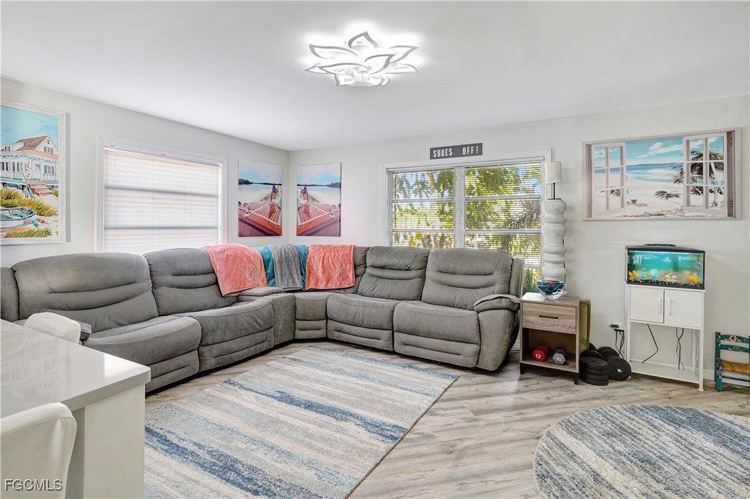 5887 Kingfish Road Bokeelia, FL 33922 - Photo 2 of 34 a living room with furniture and a fireplace