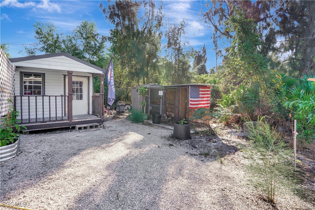 5887 Kingfish Road Bokeelia, FL 33922 - Photo 24 of 34 a view of a house with a yard and a tree