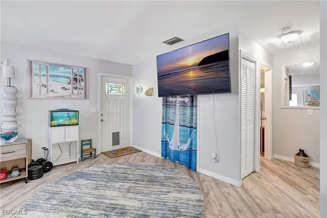 a bedroom with furniture and a wooden floor