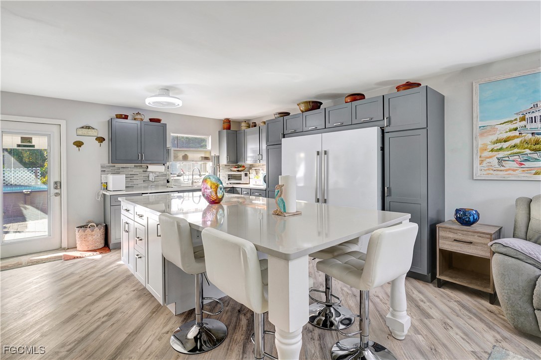 5887 Kingfish Road Bokeelia, FL 33922 - Photo 4 of 34 a kitchen with stainless steel appliances a refrigerator and a table