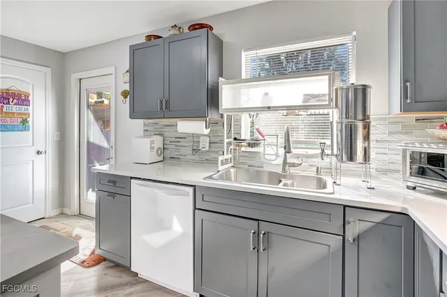 a kitchen with a sink window and cabinets