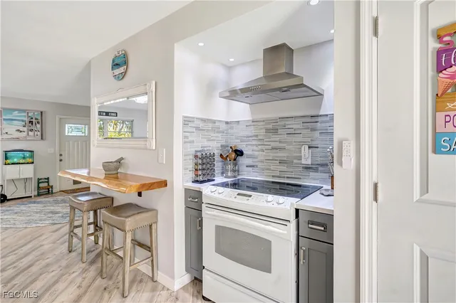 a kitchen with stainless steel appliances kitchen island granite countertop a stove and a refrigerator