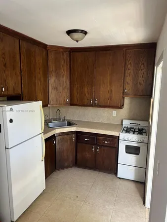 a kitchen with a cabinets and white appliances