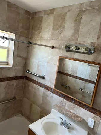 a bathroom with a sink and shower