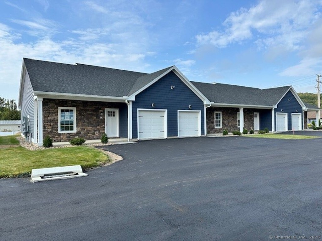 a front view of a house with a yard and porch