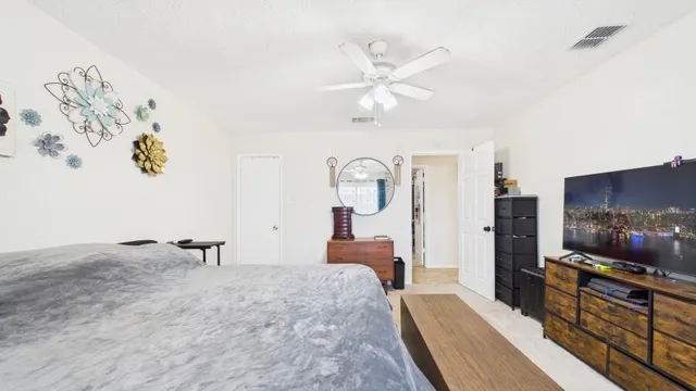 a bedroom with a bed and a chandelier