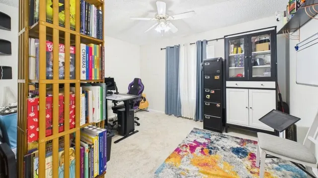 a bedroom with furniture and a book shelf
