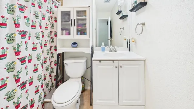 a white toilet sitting next to a bathroom sink