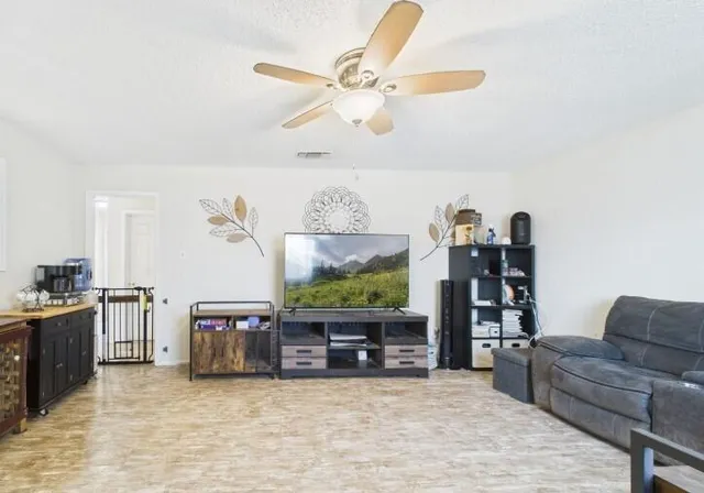 a living room with furniture and kitchen view