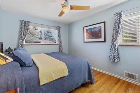 a bed sitting in a bedroom next to a window