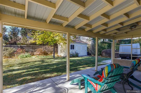 a view of backyard with swimming pool and outdoor seating