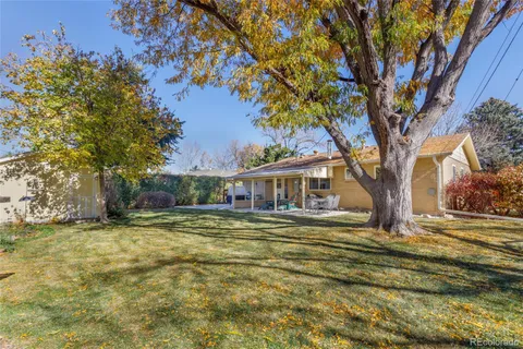 a view of a house with a large tree