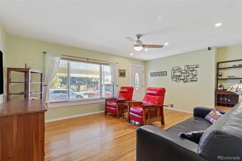 a living room with furniture and a floor to ceiling window