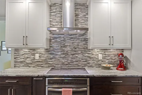a kitchen with granite countertop cabinets sink and stainless steel appliances