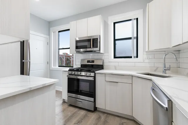 a kitchen with stainless steel appliances a sink stove and microwave