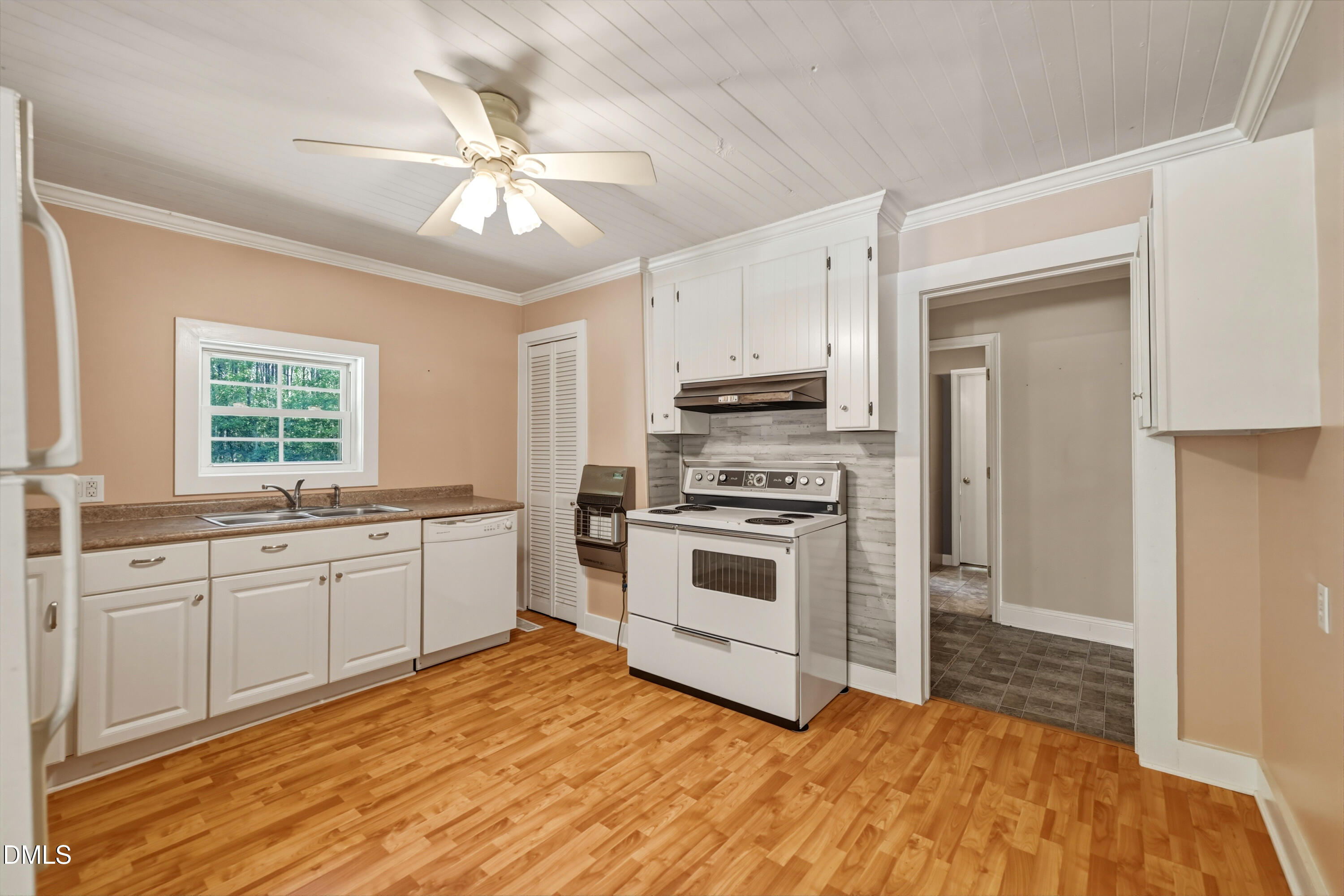 50 Robert Sledge Road Spring Hope, NC 27882 - Photo 18 of 50 a kitchen with stainless steel appliances a stove a sink and white cabinets