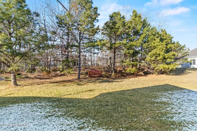 a view of a yard with wooden fence