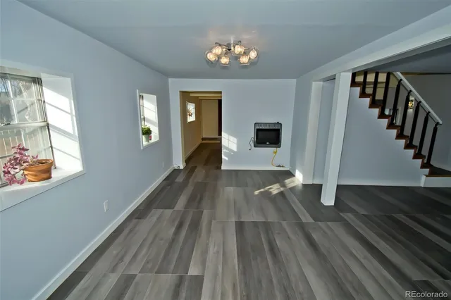 a view of a living room with hardwood floor and a ceiling fan