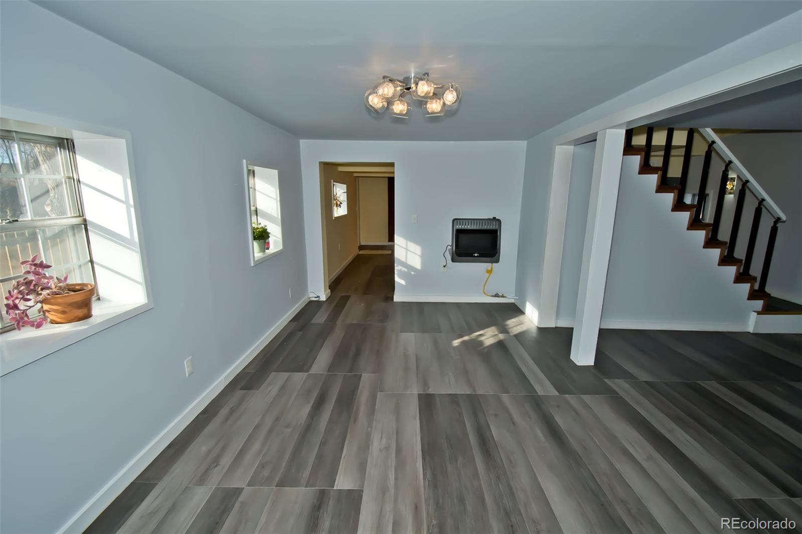 355 9th Street Saguache, CO 81149 - Photo 20 of 42 a view of a living room with hardwood floor and a ceiling fan