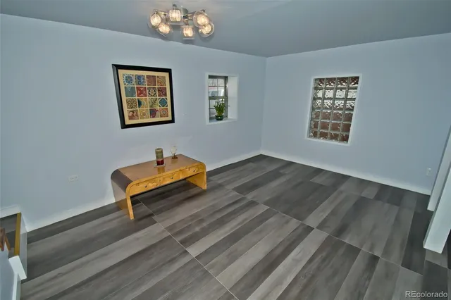 a room with a bench and paintings on the wall