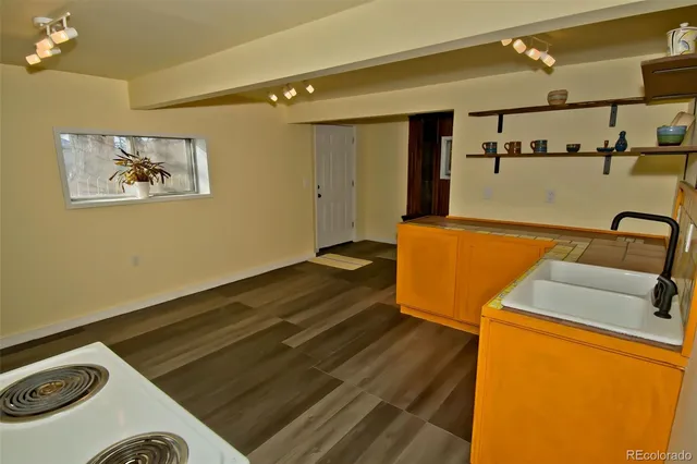 a view of kitchen with stainless steel appliances cabinets and wooden floor