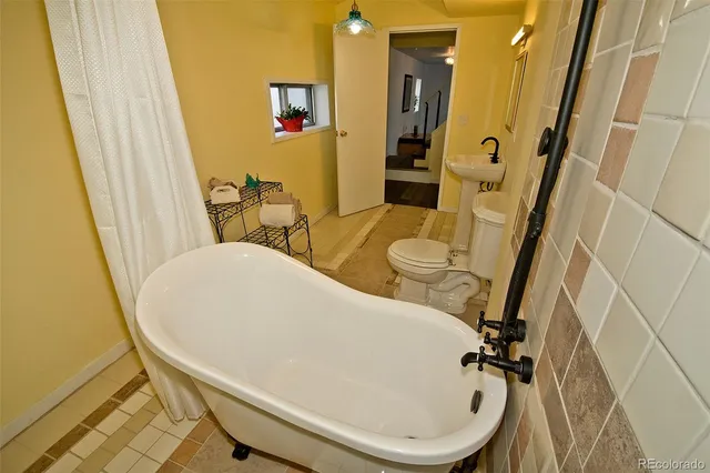 a bathroom with a granite countertop toilet sink and mirror