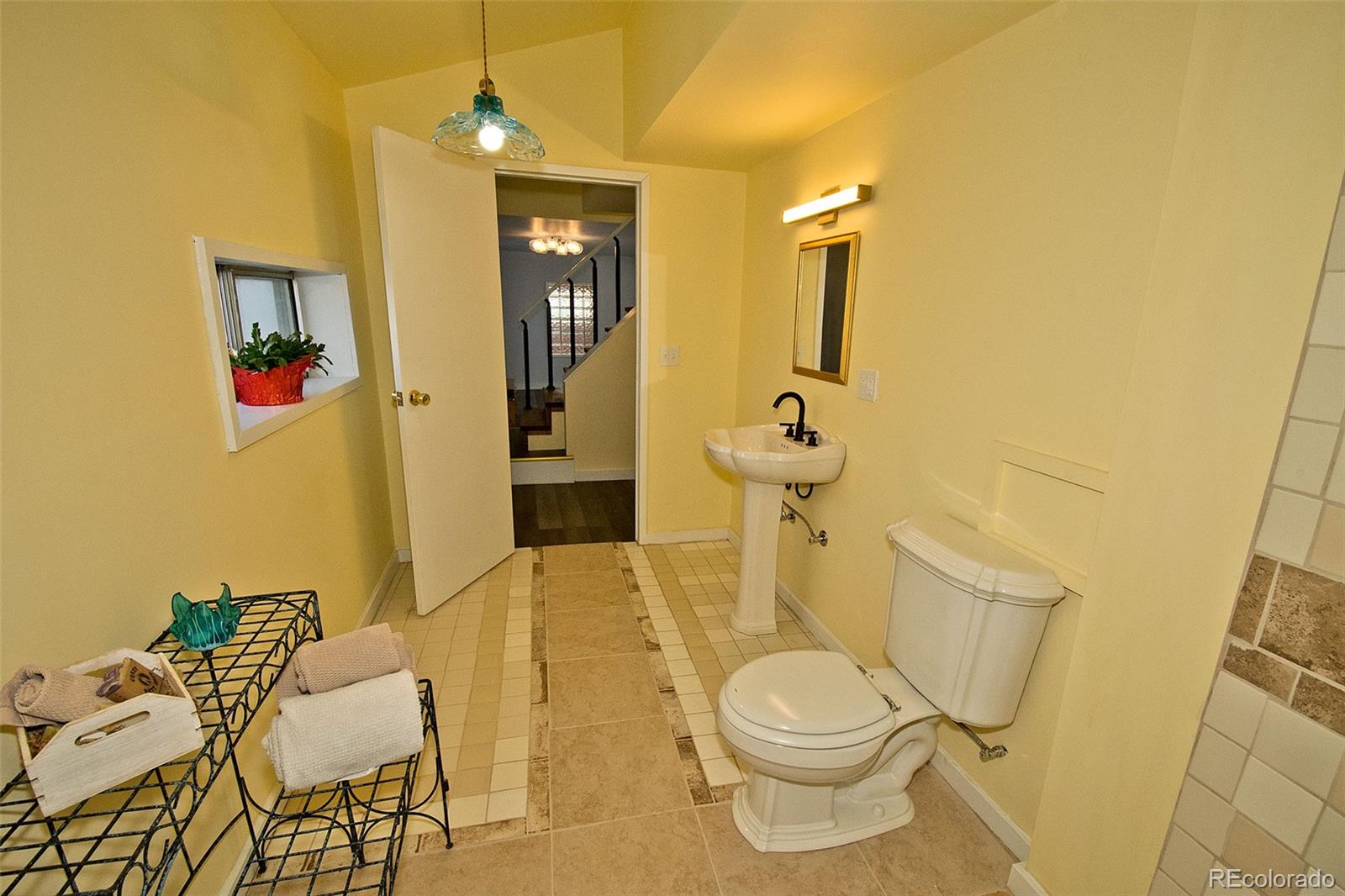 355 9th Street Saguache, CO 81149 - Photo 29 of 42 a bathroom with a granite countertop toilet sink and mirror