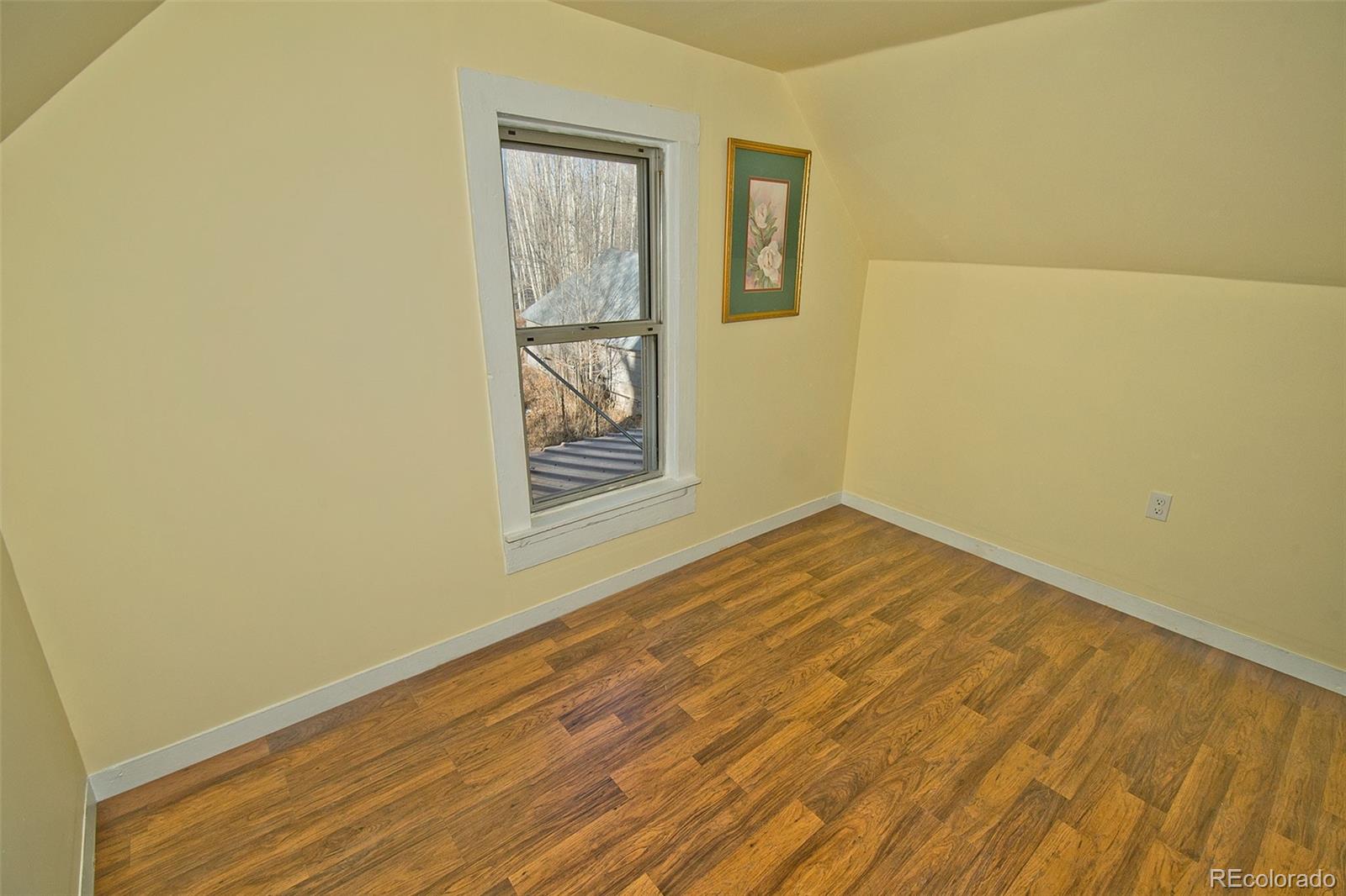 355 9th Street Saguache, CO 81149 - Photo 37 of 42 a view of empty room with wooden floor and fan