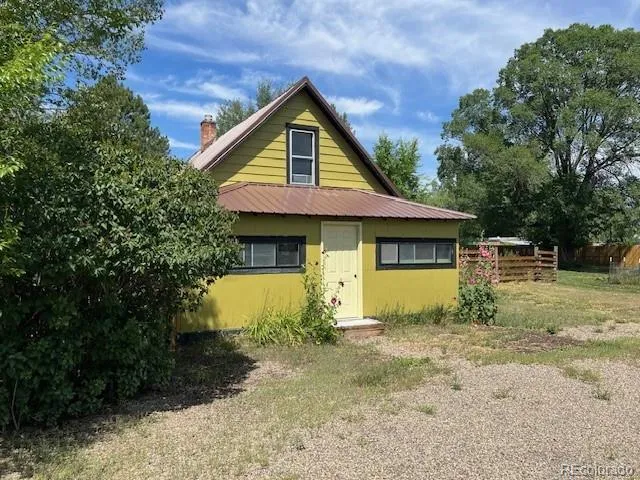 a view of a house with large windows and a yard