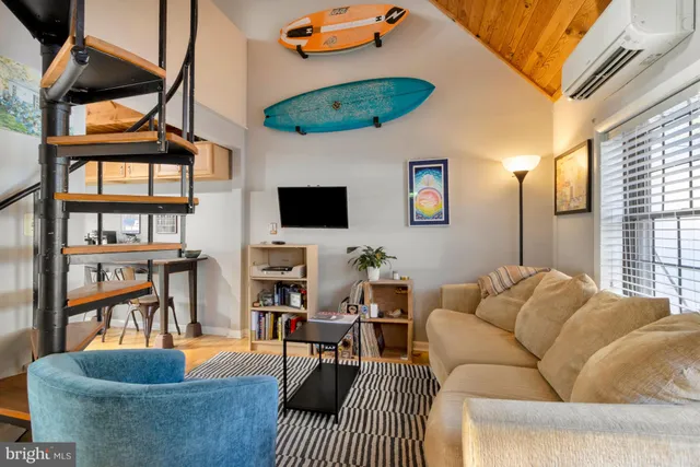 a living room with furniture a rug and a window