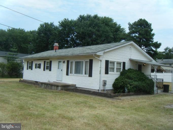 7922 Shore Road Sparrows Point, MD 21219 - Photo 1 of 8 a front view of a house with a garden