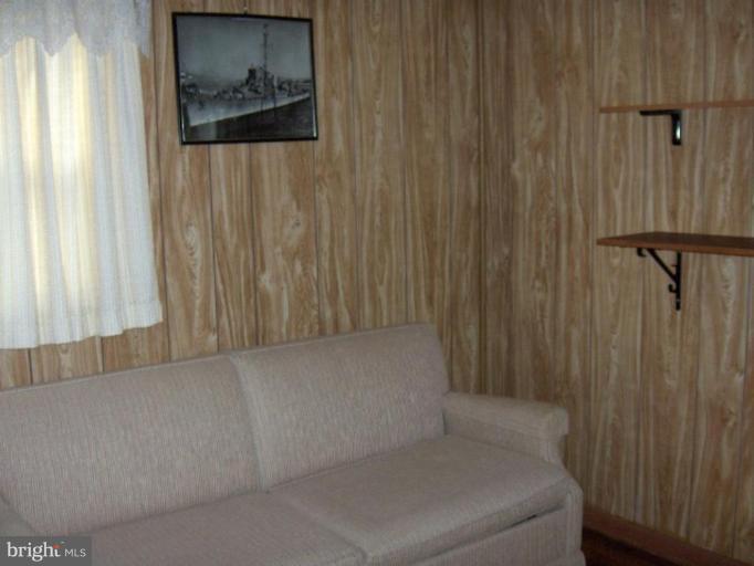 7922 Shore Road Sparrows Point, MD 21219 - Photo 7 of 8 a hallway with sliding door and couch