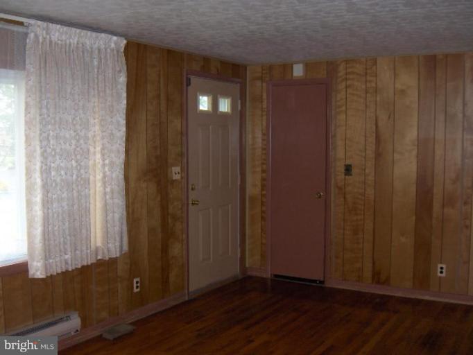 7922 Shore Road Sparrows Point, MD 21219 - Photo 8 of 8 a view of a hallway with wooden floor