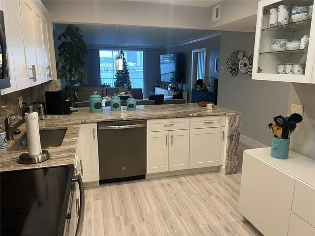 a kitchen with a stove top oven sink and cabinets