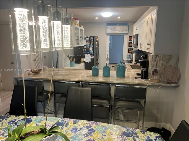 a kitchen with stainless steel appliances kitchen island granite countertop a sink and cabinets