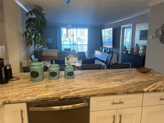 a view of a kitchen with granite countertop a living room