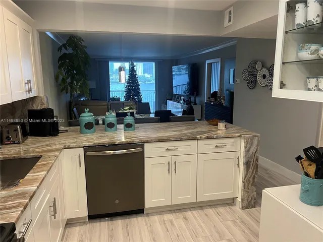 a kitchen with sink stove and cabinets