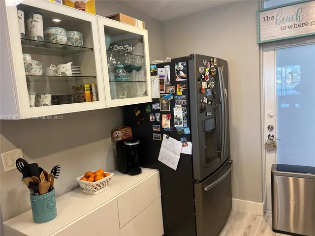 a kitchen with a refrigerator and cabinets
