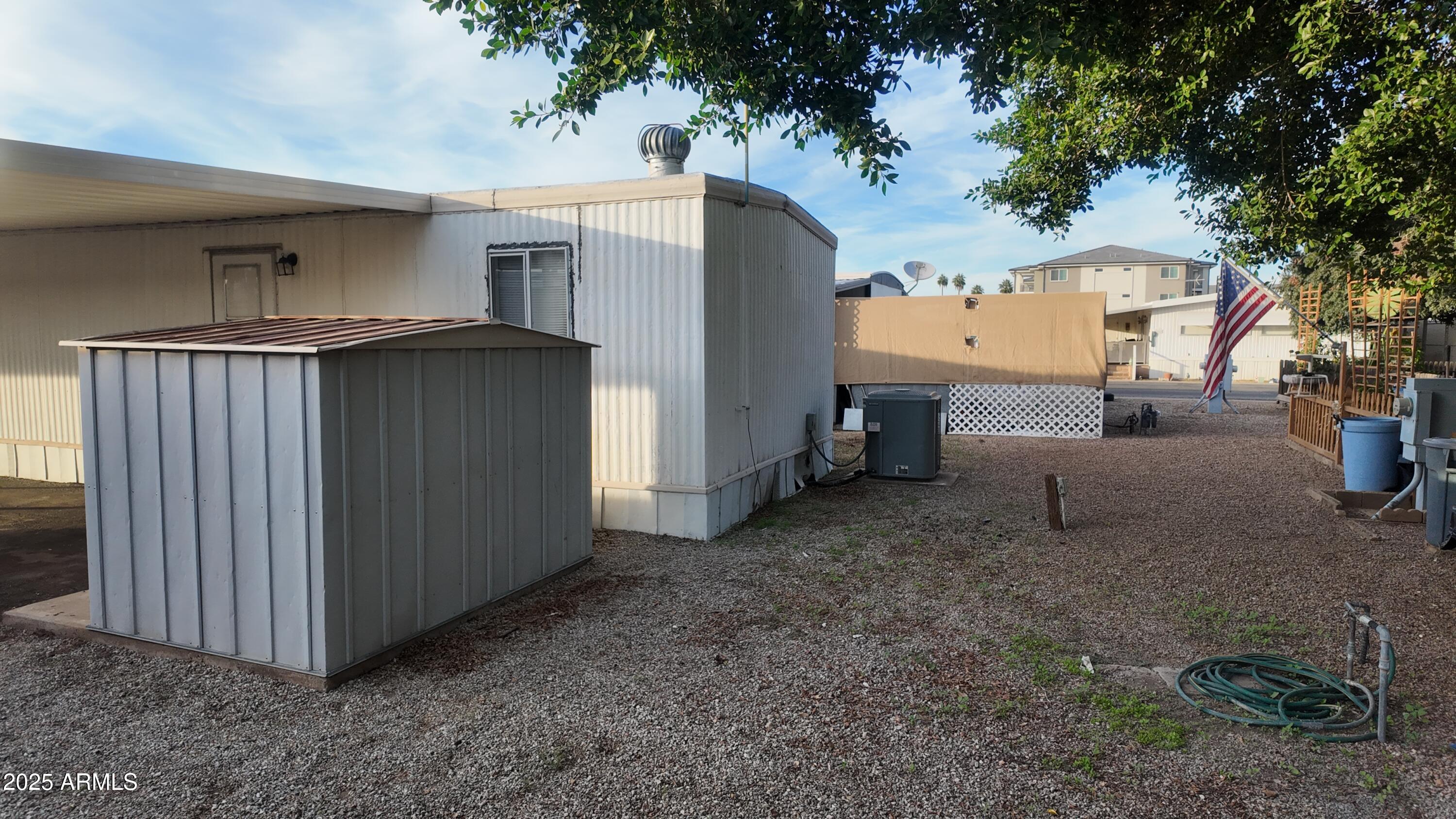 4800 West Ocotillo Road, Unit 105 Glendale, AZ 85301 - Photo 20 of 20 a view of a house with backyard and trees