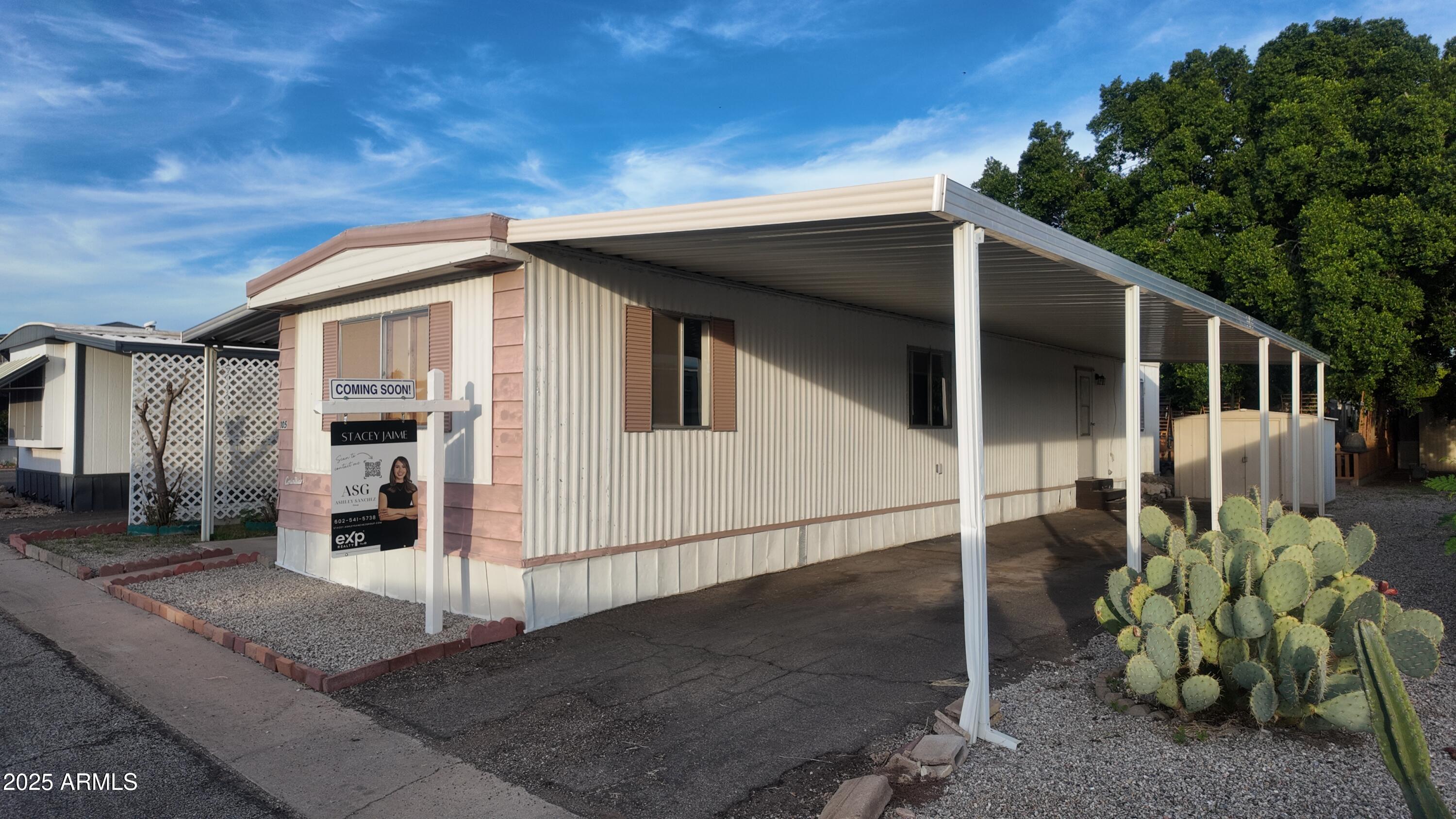 4800 West Ocotillo Road, Unit 105 Glendale, AZ 85301 - Photo 2 of 20 a white house with a large window and potted plants