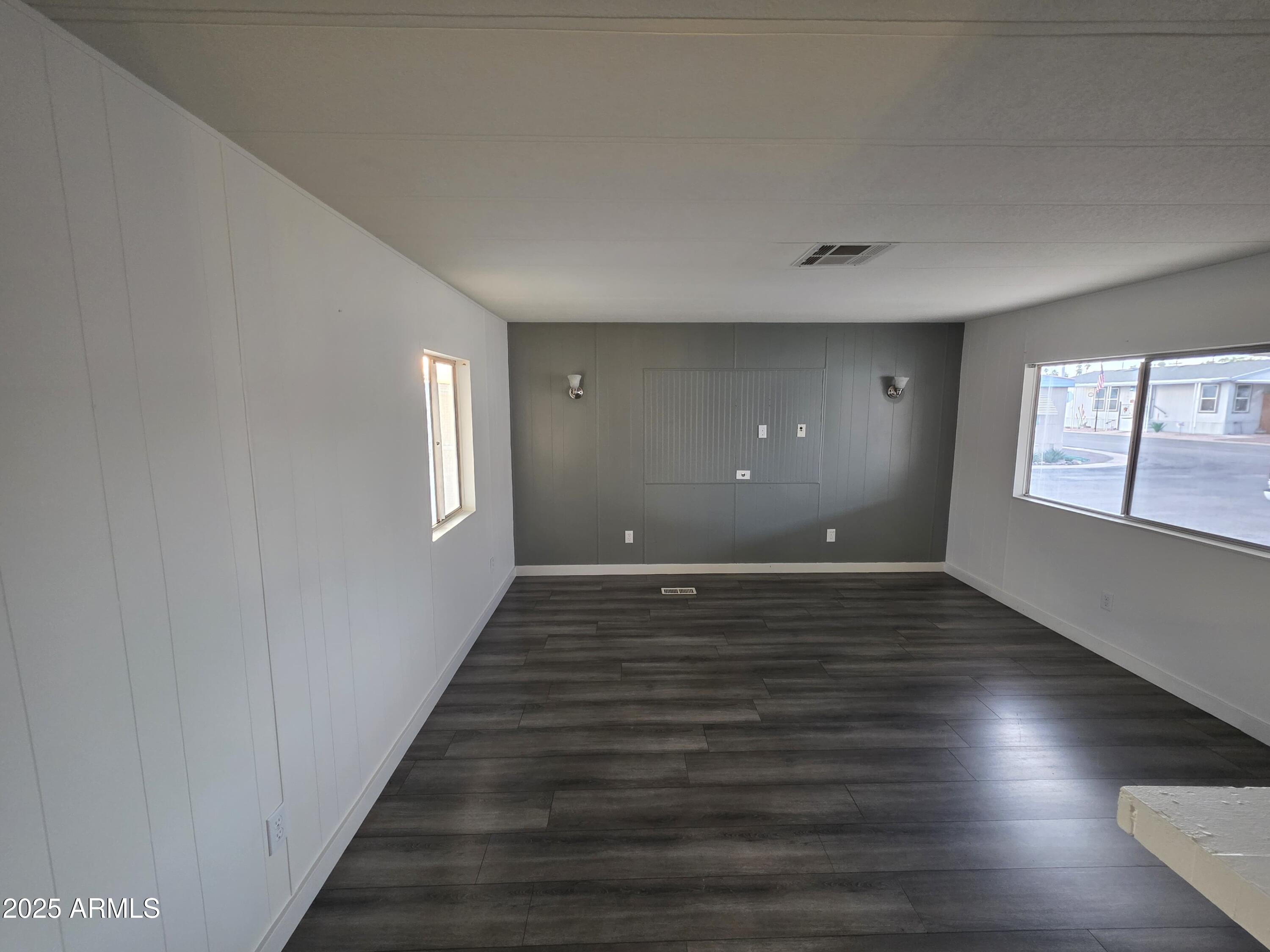 4800 West Ocotillo Road, Unit 105 Glendale, AZ 85301 - Photo 5 of 20 a view of an empty room with wooden floor and a window