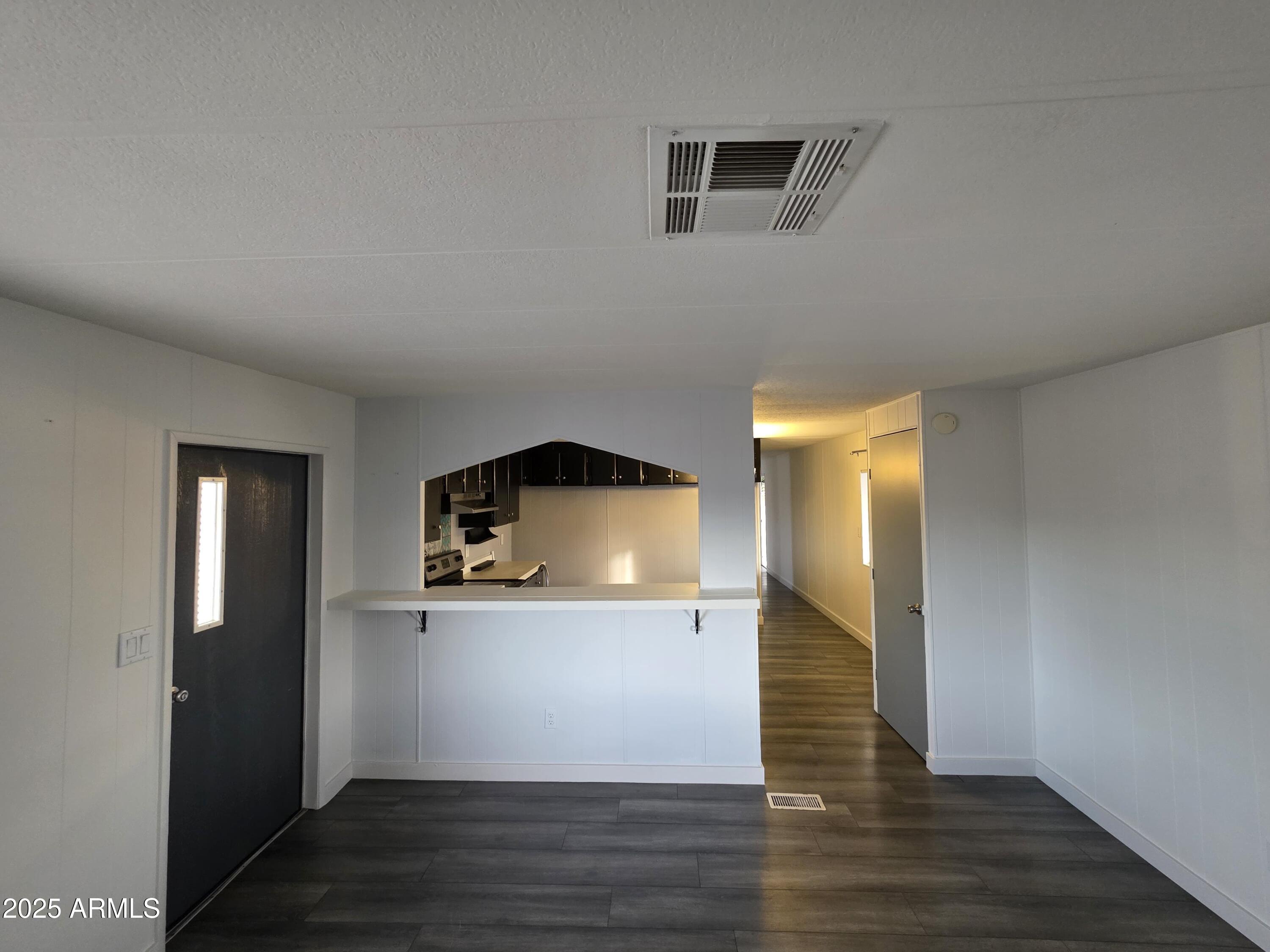 4800 West Ocotillo Road, Unit 105 Glendale, AZ 85301 - Photo 6 of 20 a view of a kitchen cabinets a wooden floor and a kitchen