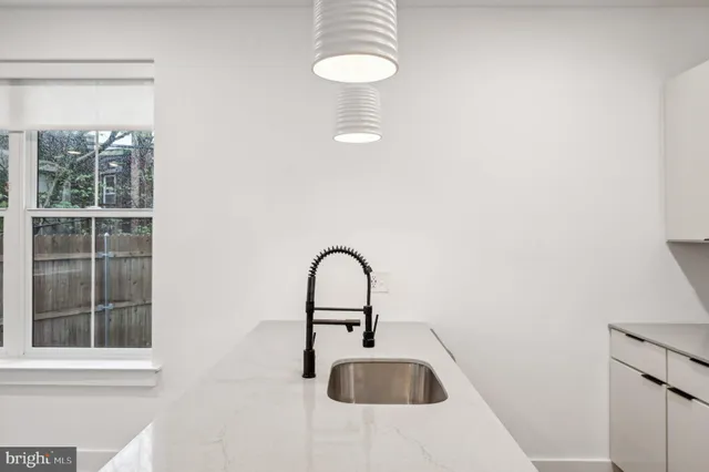 a kitchen with stainless steel appliances granite countertop a sink a stove and a refrigerator